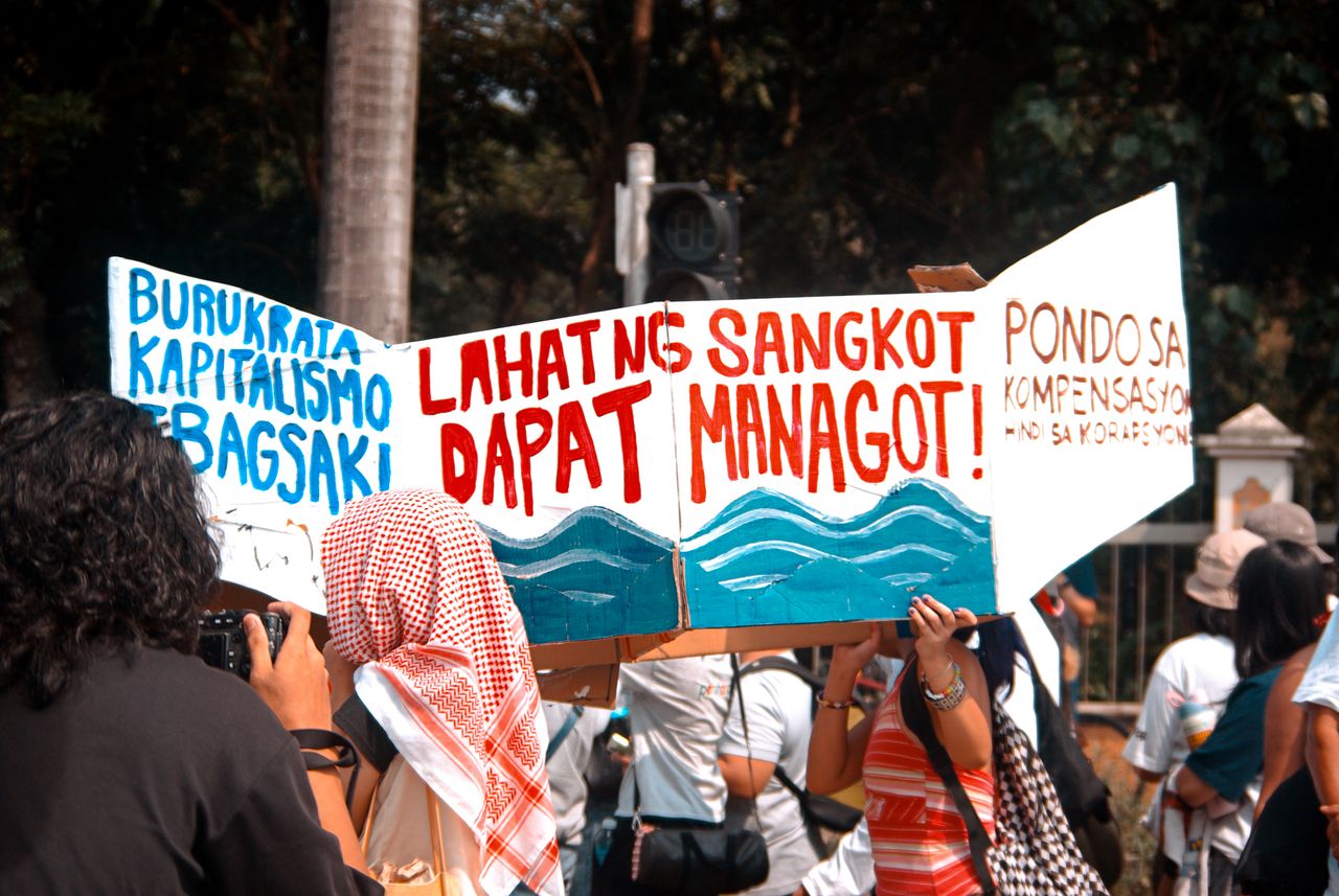 Protesters with bold banners advocating for social change during a street demonstration.